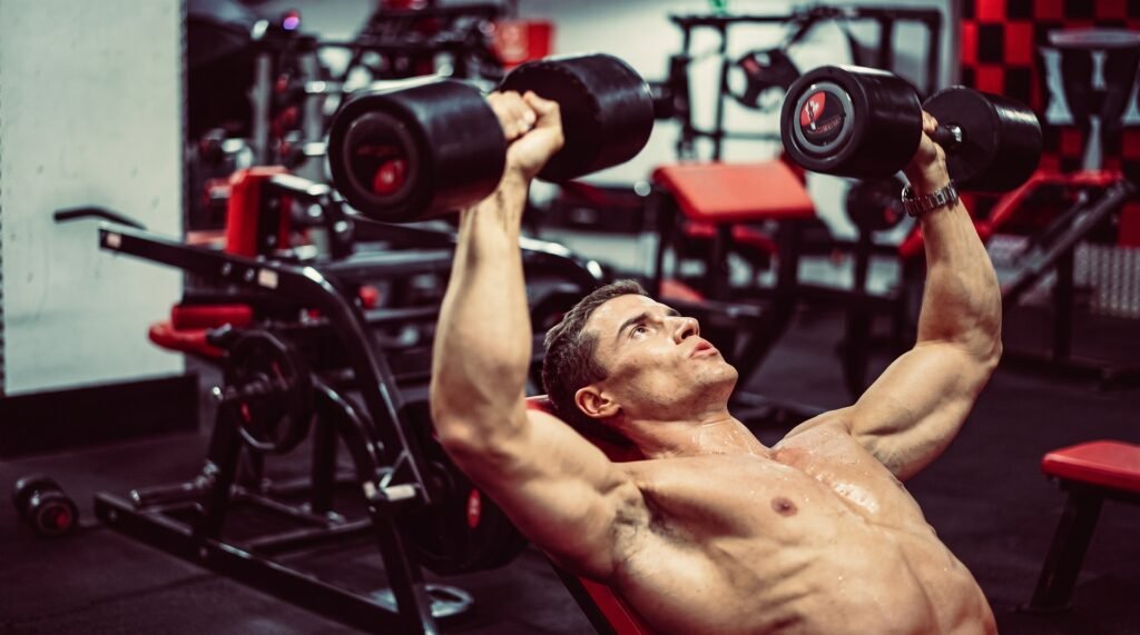 Man doing incline bench press in the gym