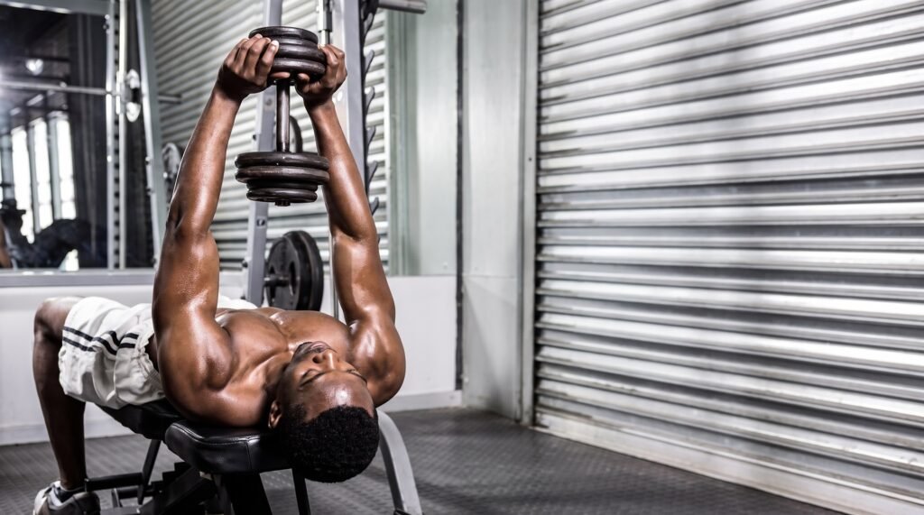 Man performing a dumbbell pullover holding one dumbbell over his chest
